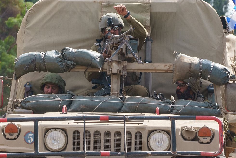 Photograph of an Israeli soldier driving a military vehicle.