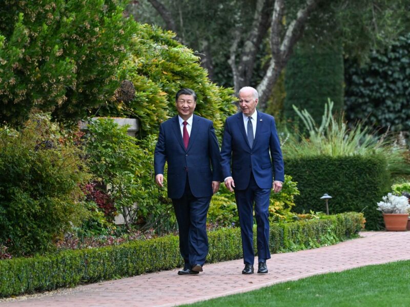 Photograph of Chinese President Xi Jinping and U.S. President Joe Biden walking side by side in the Filoli Estate in the U.S. state of California​