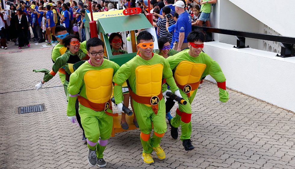 Photograph of ​a group dressed up as mutant ninja turtles for the sedan race.