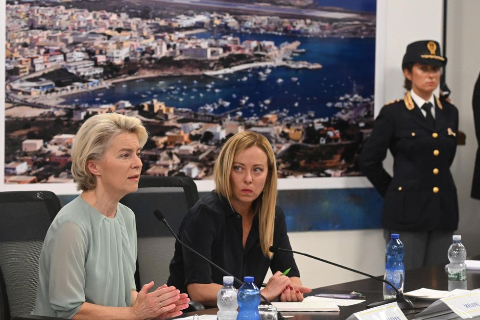 Photograph of ​Italian Premier Giorgia Meloni and EU Commission President Ursula von der Leyen sitting next to one another as they attend a press conference in Lampedusa.