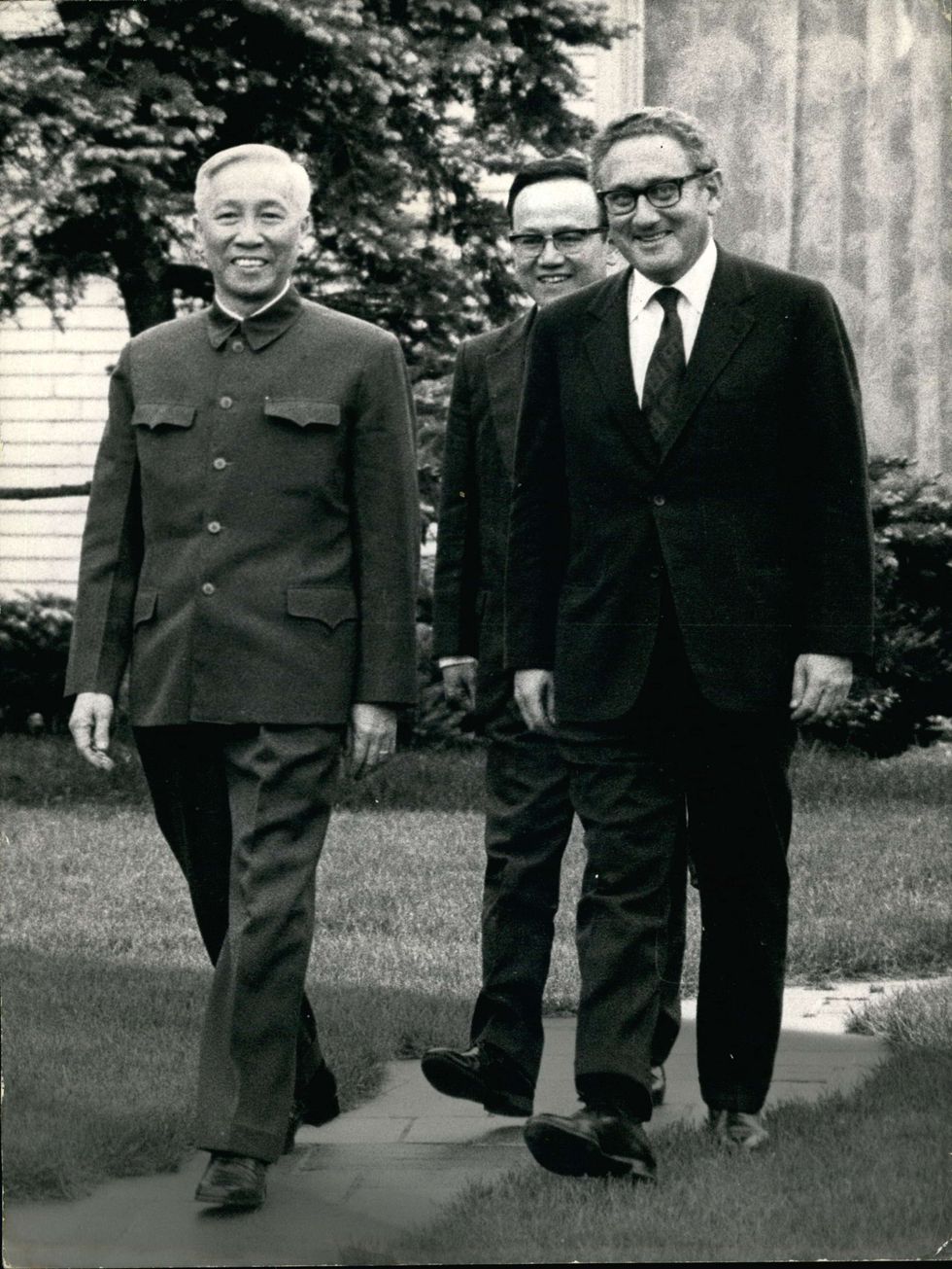 Photograph of Henry Kissinger walking with Vietnamese leader Le DucC Tho at St. Nom-la-Breteche Villa