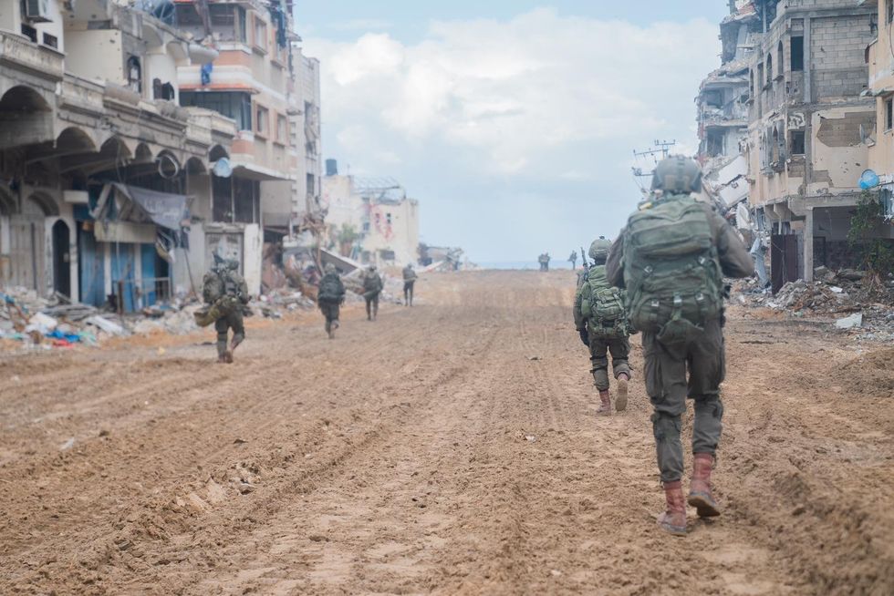 Photograph of IDF soldiers walking in Gaza