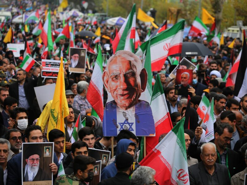 Photograph of Iranian Demonstrators holding Palestinian flags and a caricature of Prime Minister of Israel Benjamin Netanyahu​