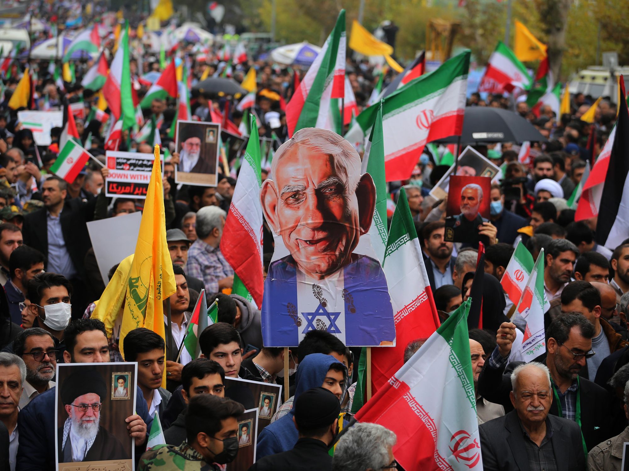 Photograph of Iranian Demonstrators holding Palestinian flags and a caricature of Prime Minister of Israel Benjamin Netanyahu​