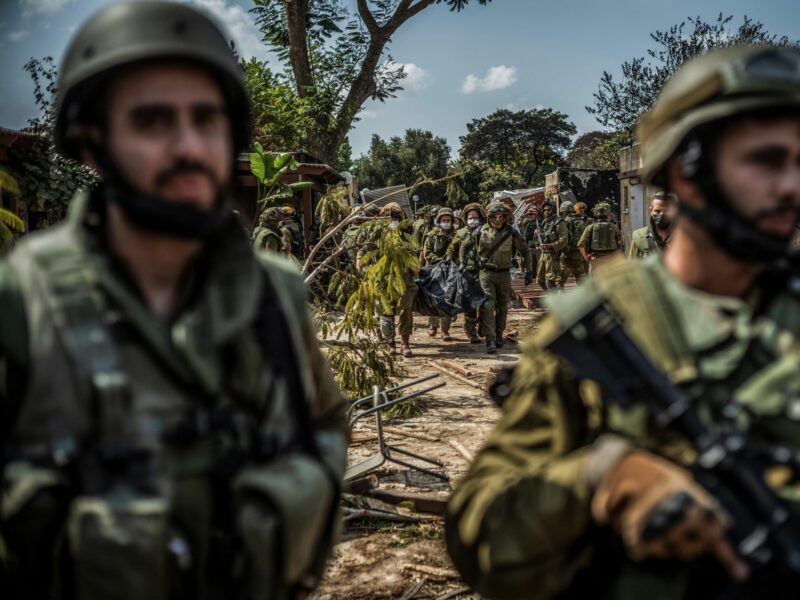 Photograph of Israeli forces extracting the dead bodies of Israeli residents from a destroyed house.​