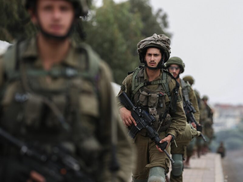 Photograph of Israeli soldiers walking in full gear