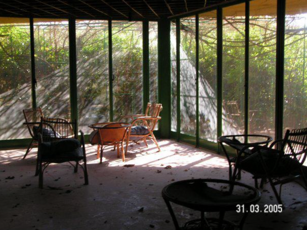 Photograph of old chairs arranged in the abandoned resort of Otranto Country Club