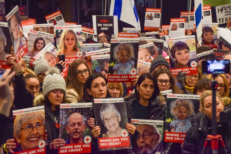 Photograph of Pro-Israel protesters holding up photographs of Israeli hostages.