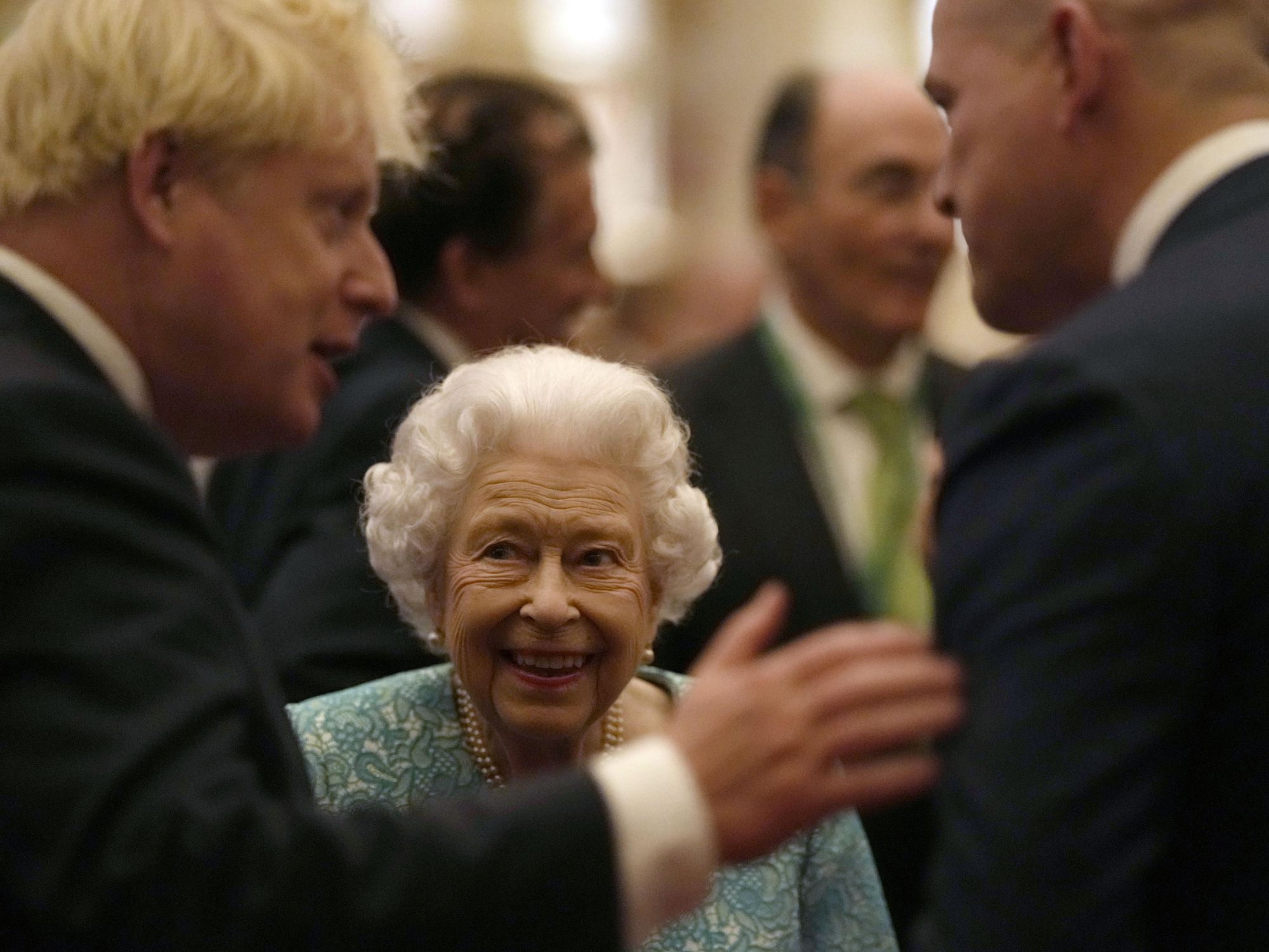 Photograph of Queen Elizabeth II talking with UK Prime Minister Boris Johnson at a reception for international business and investment leaders at Windsor Castle during yesterday’s Global Investment Summit. Today, the 95-year-old British monarch was advised by her doctors to cancel a two-visit to Northern Ireland, although she is reportedly “in good spirits”.