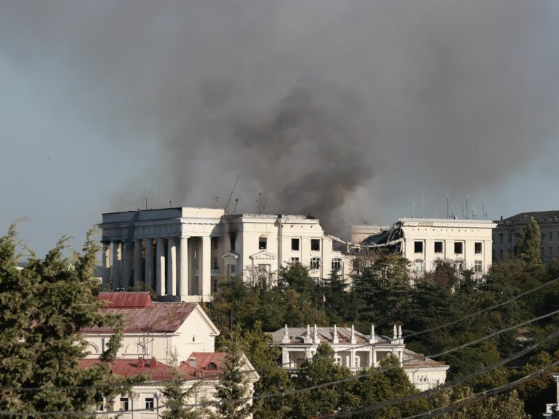 Photograph of the Russian Black Sea Fleet headquarters with smoke rising above it after a Ukrainian missile strike.