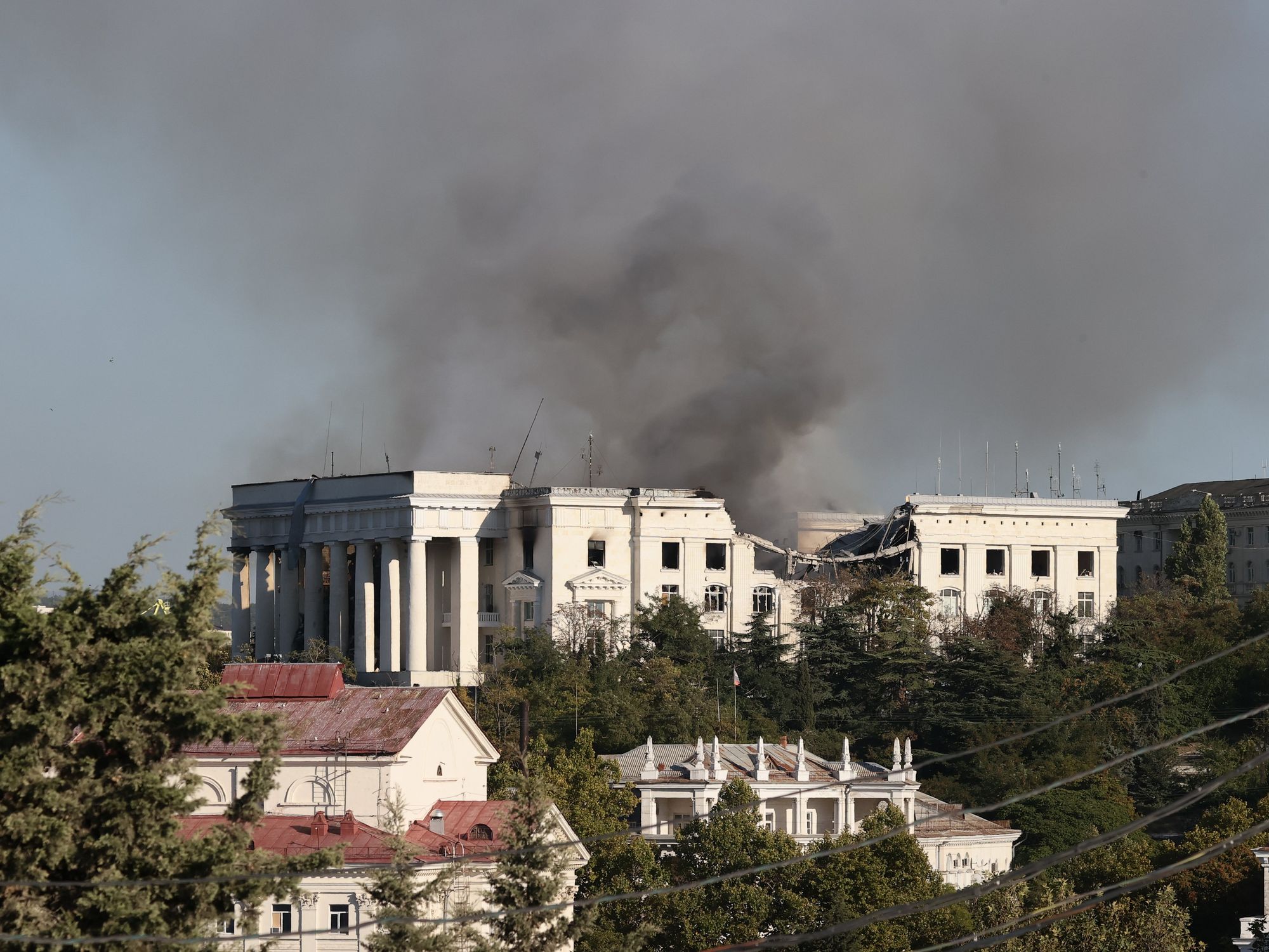 Photograph of the Russian Black Sea Fleet headquarters with smoke rising above it after a Ukrainian missile strike.