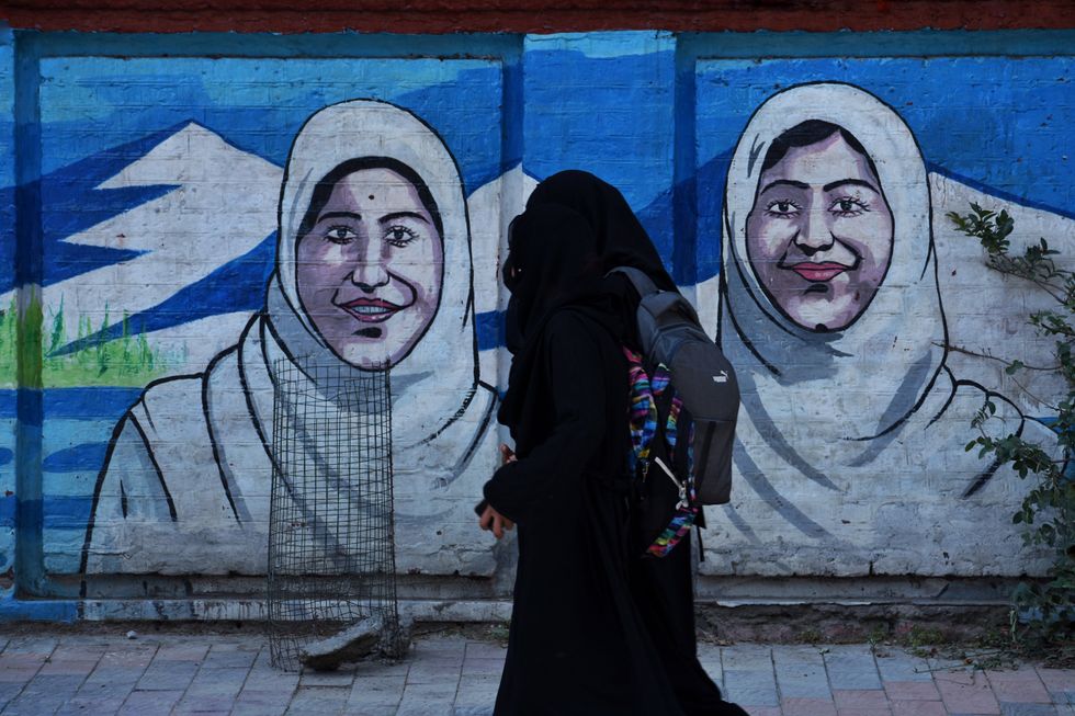 Photograph of Two Kashmiri female students and Muslim women wearing 'Hijab' on their walk back from school.