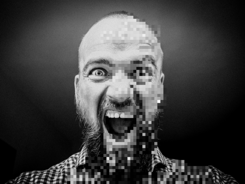 Photoshoped picture of a bald man shouting, with half his face pixelated