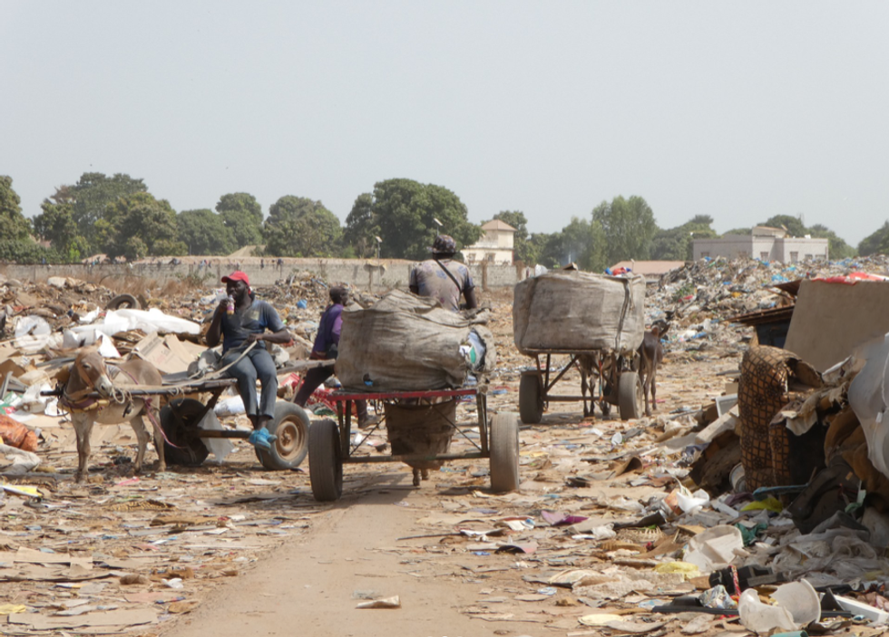 Picking material to resell or recycle from the landfill.
