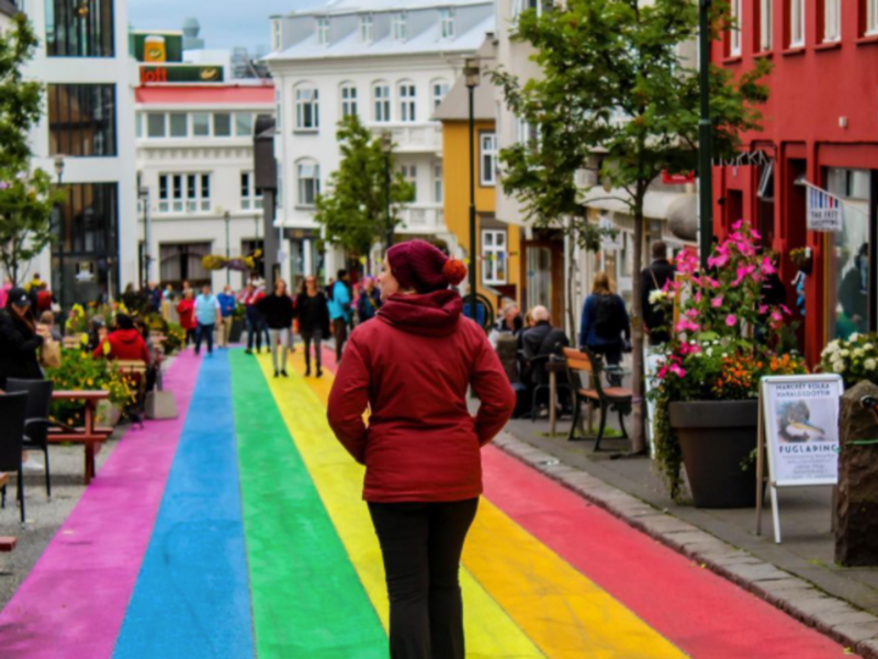 Picture of a woman walking on Reykvavik's famous Rainbow Street