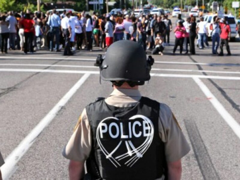 Police await protesters in Ferguson on Aug. 13.