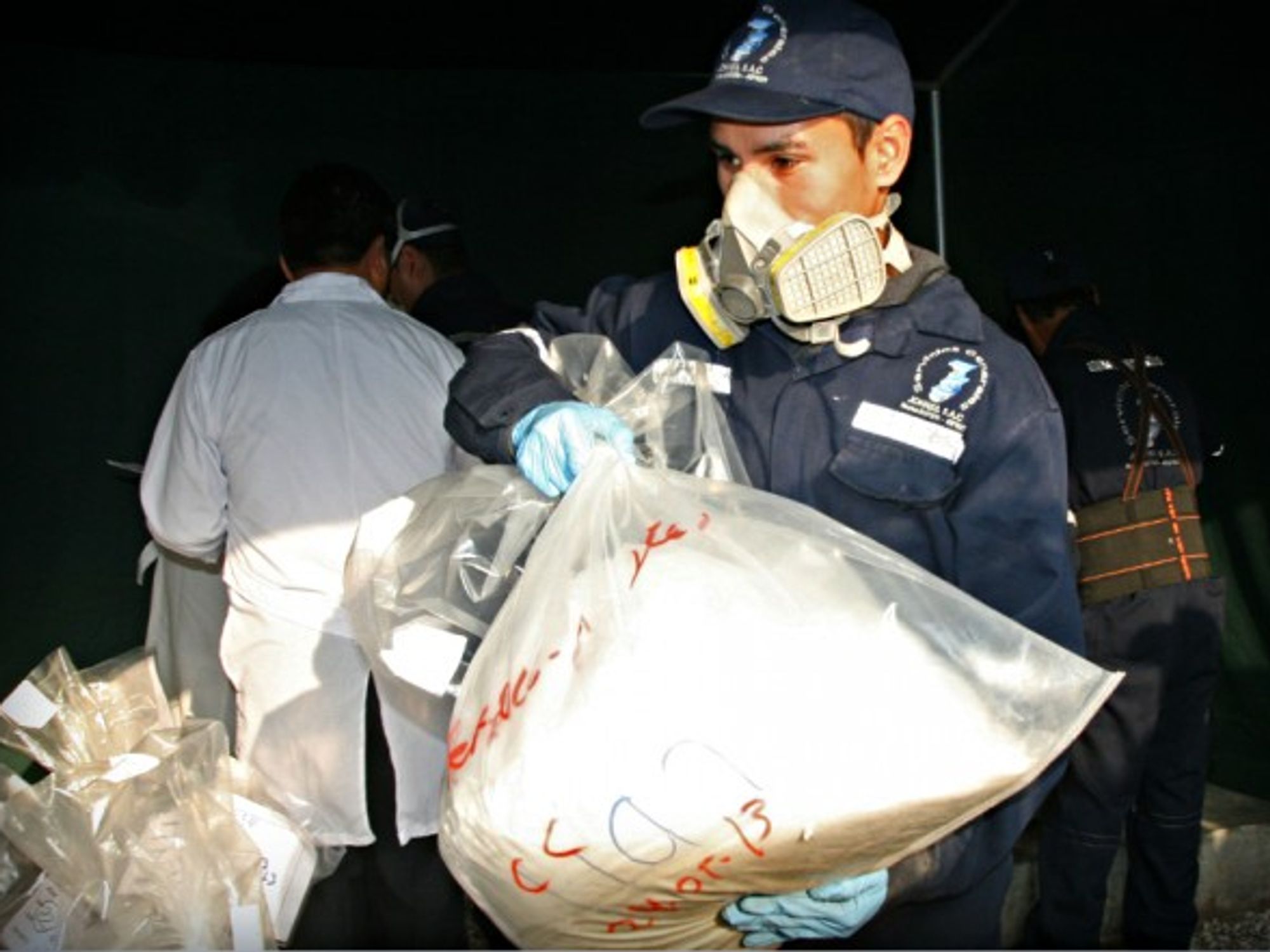 Police officer seizing drugs in Ate Vitarte, Peru