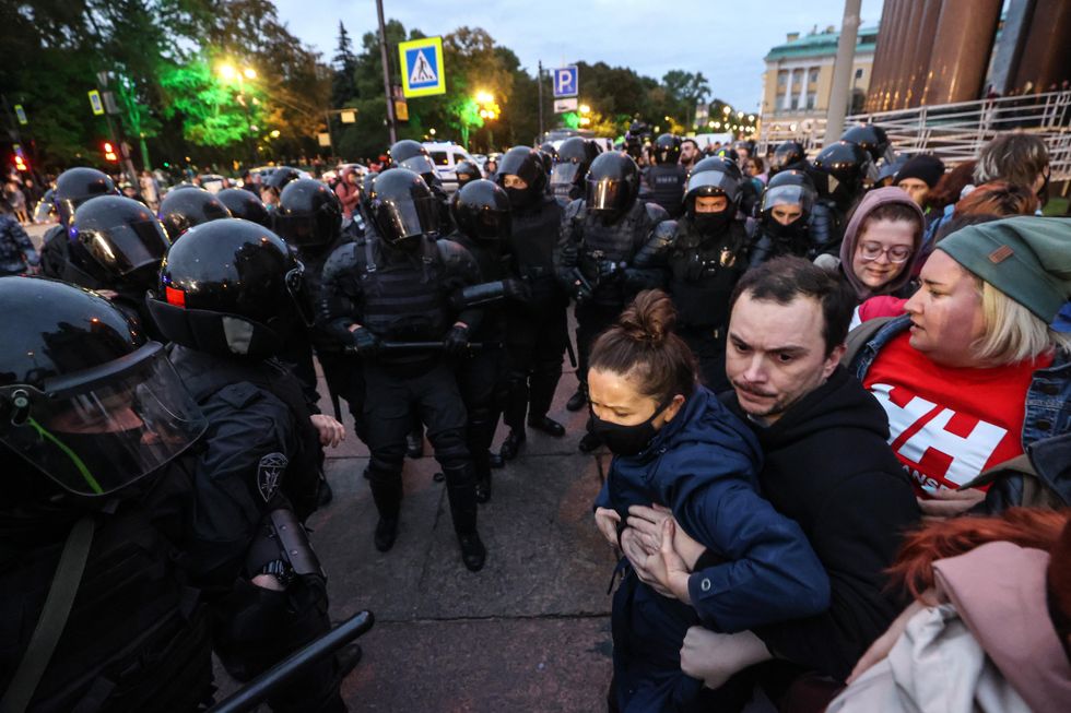 Police officers clash with protesters during an anti-mobilization rally in St Petersburg.
