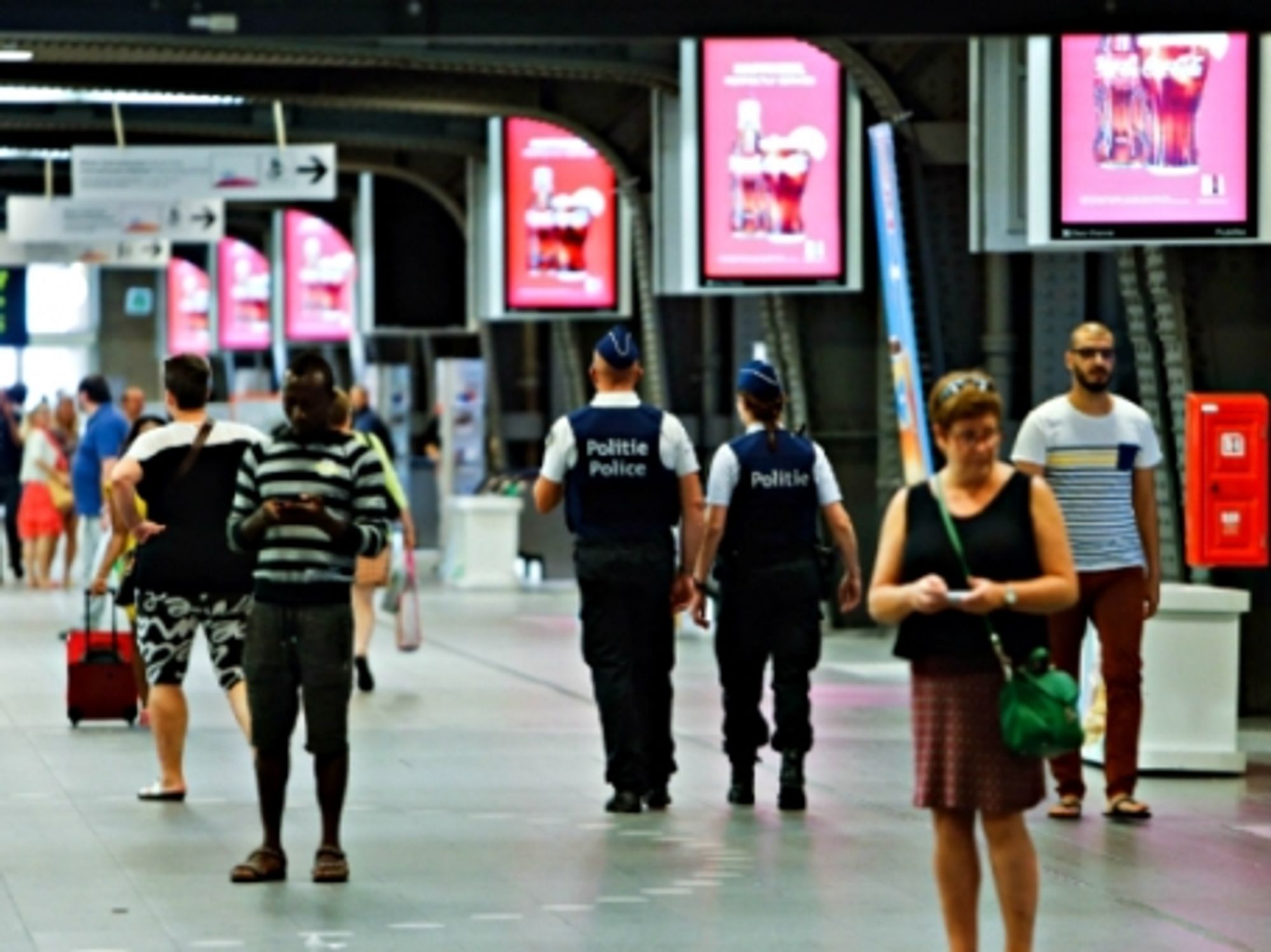 Police officers patrol the Brussels Midi station in the capital of Belgium on Aug. 23, 2015.