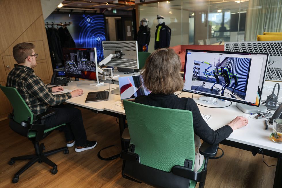Police officers work on processing data from a police robot dog in the police Innovation Lab.