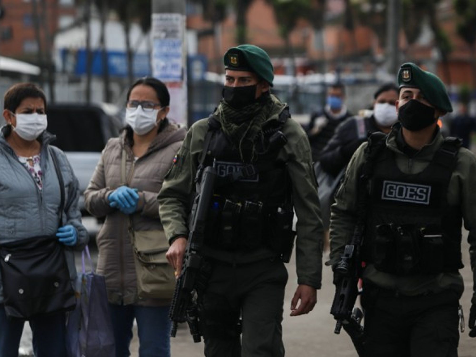 Policemen patrol a street in Soacha, Colombia.