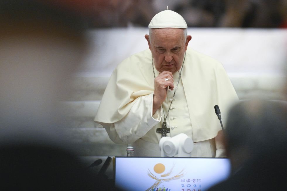 Pope Francis stoically looks down as he prepares to speak to a crowd in Vatican City.