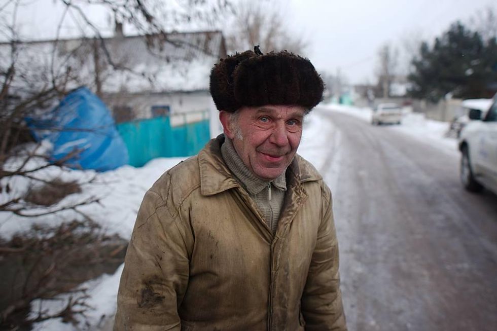 Portrait of an elderly man in a snowy village by Maks Levin