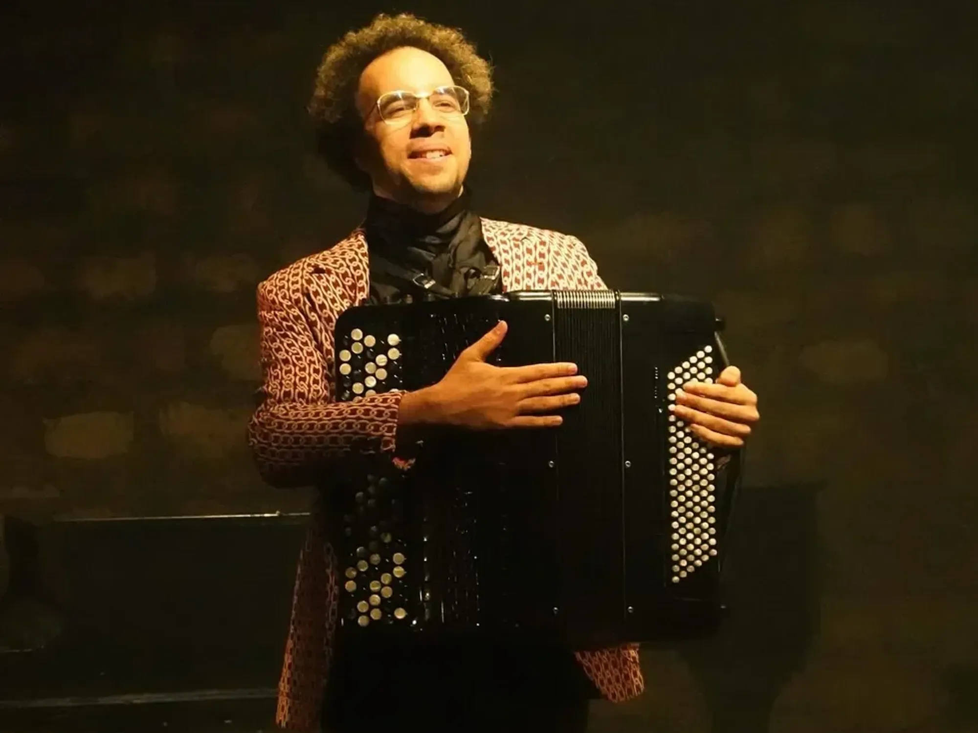 Portrait of Theo Ould playing the accordion