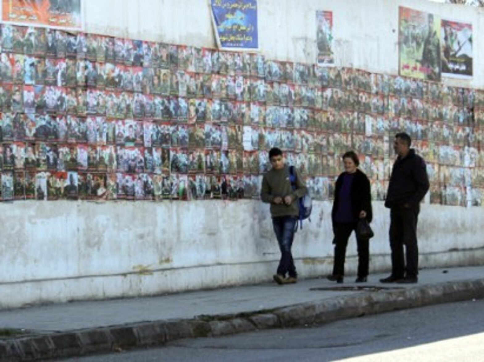 Posters of the missing or dead loved ones are hung around the city's walls