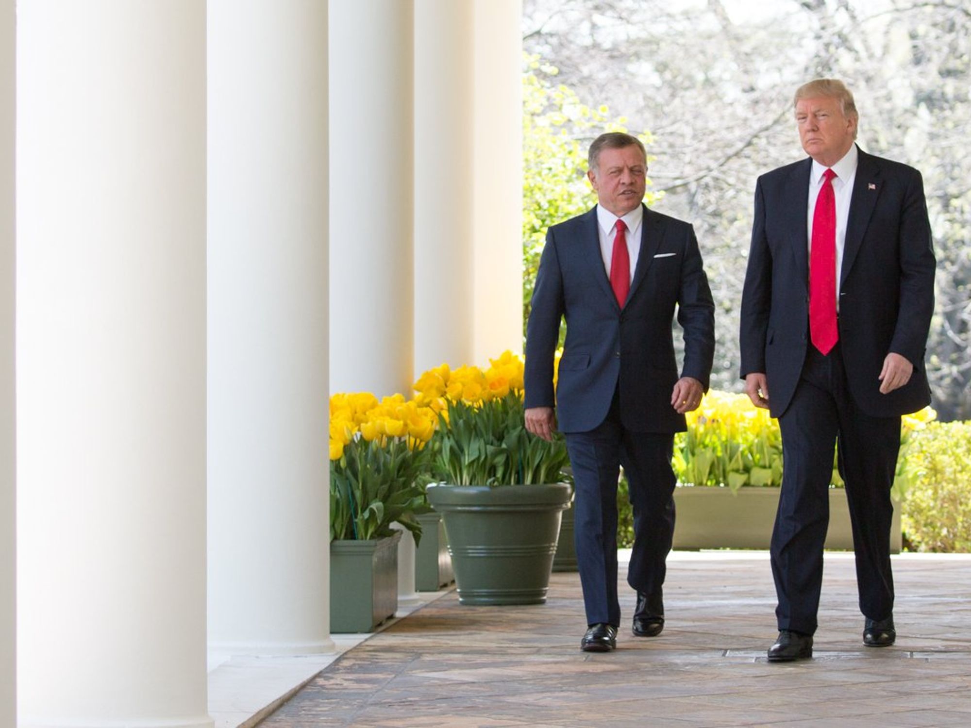 President Donald J. Trump and King Abdullah II of Jordan walk along the West Colonnade towards the podiums to begin a joint press briefing in the Rose Garden.