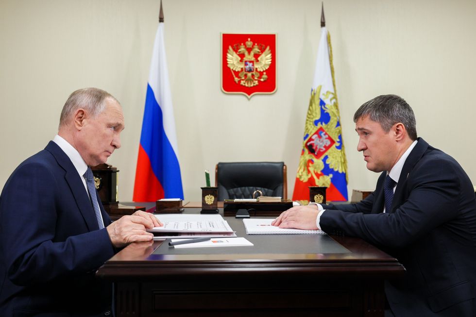 President Vladimir Putin (L) meets with Perm Region Governor Dmitry Makhonin