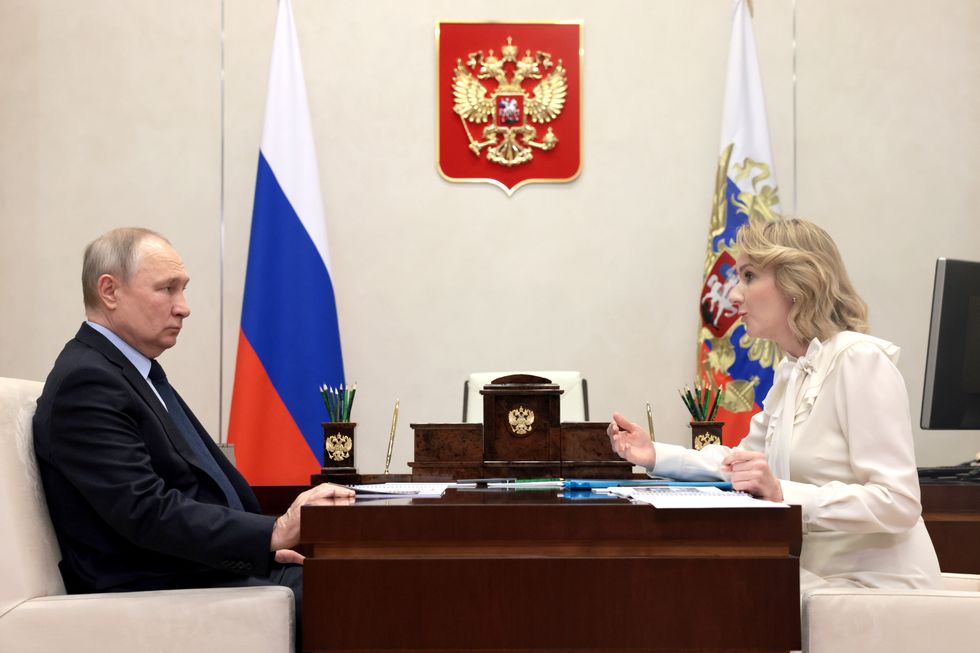 President Vladimir Putin sits across from the Commissioner for Children's Rights, Maria Lvova-Belova​