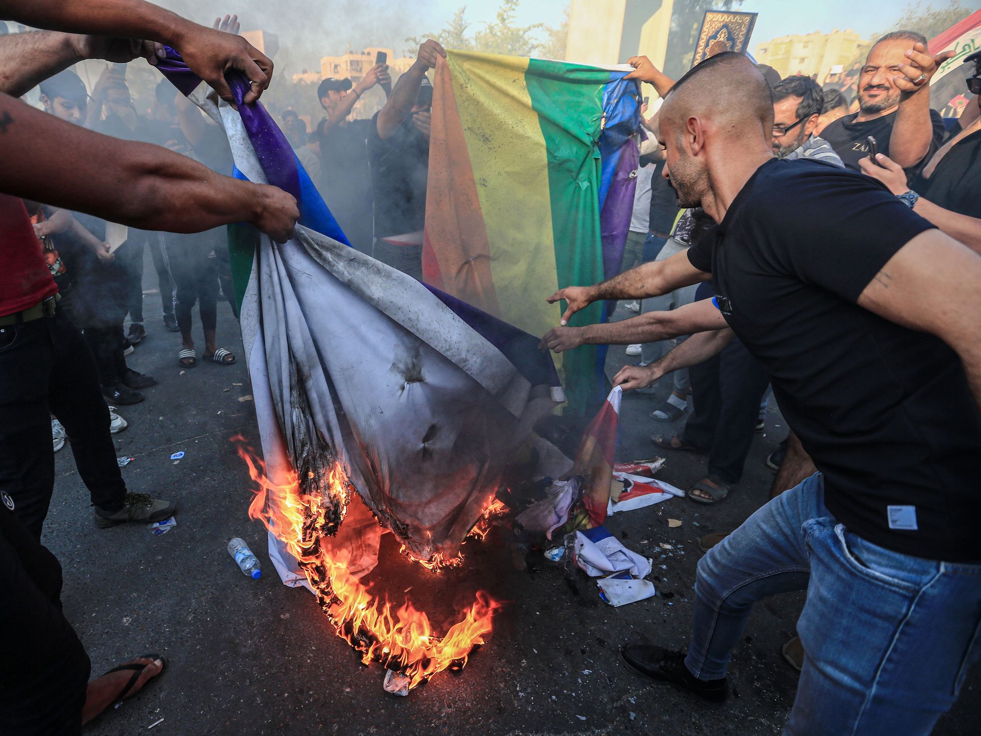 Protesters burn the LGBT (lesbian, gay, bisexual and transgender) flag.
