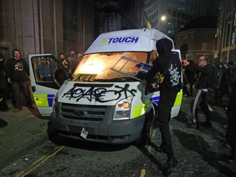 Protesters destroy a police van in Bristol during a “Kill the Bill” demonstration against a controversial new anti-crime bill.