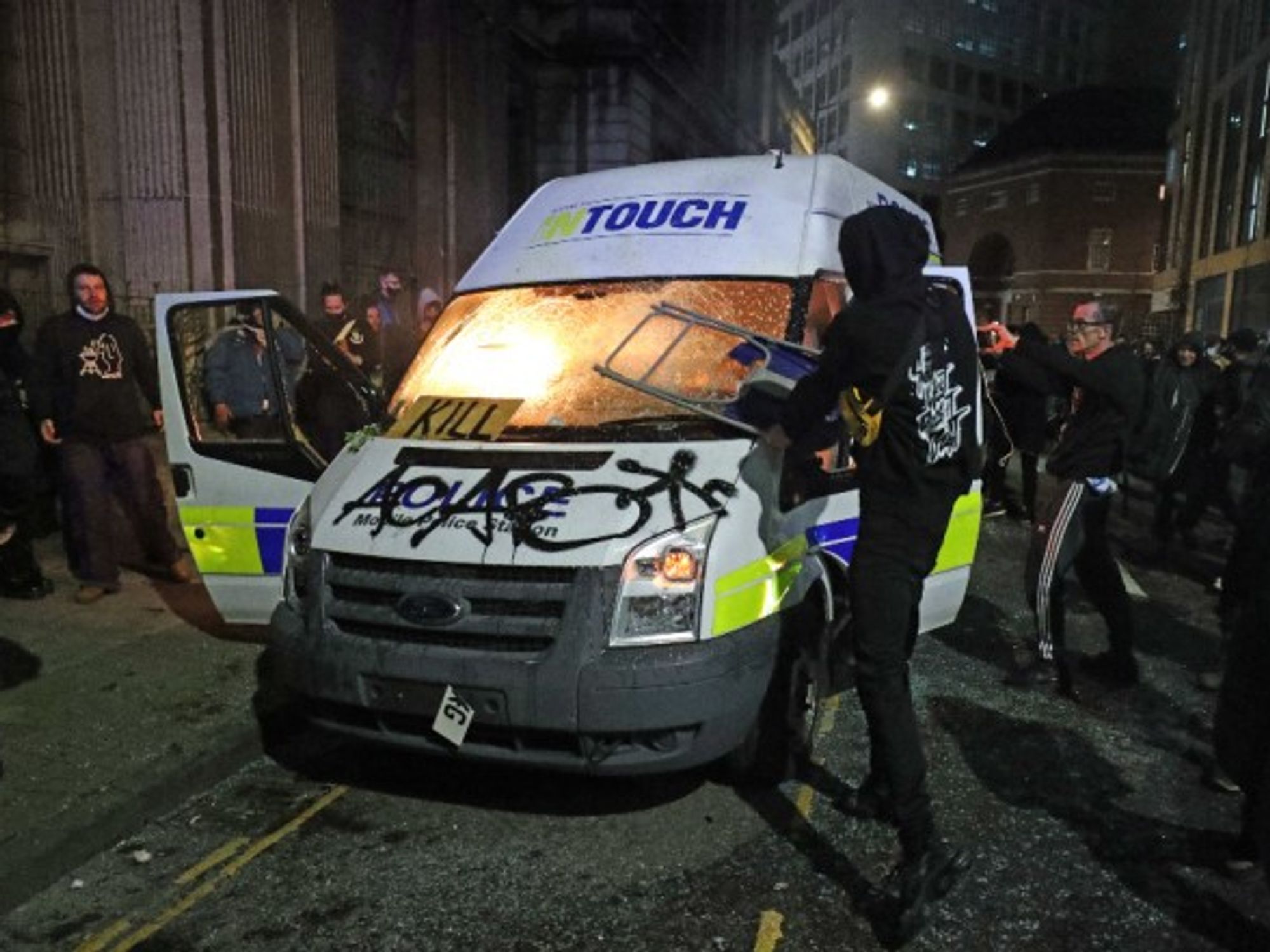 Protesters destroy a police van in Bristol during a “Kill the Bill” demonstration against a controversial new anti-crime bill.