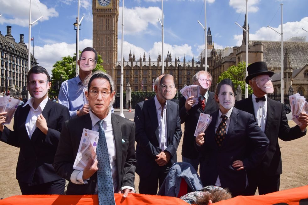 Protesters dressed as G7 leaders in London