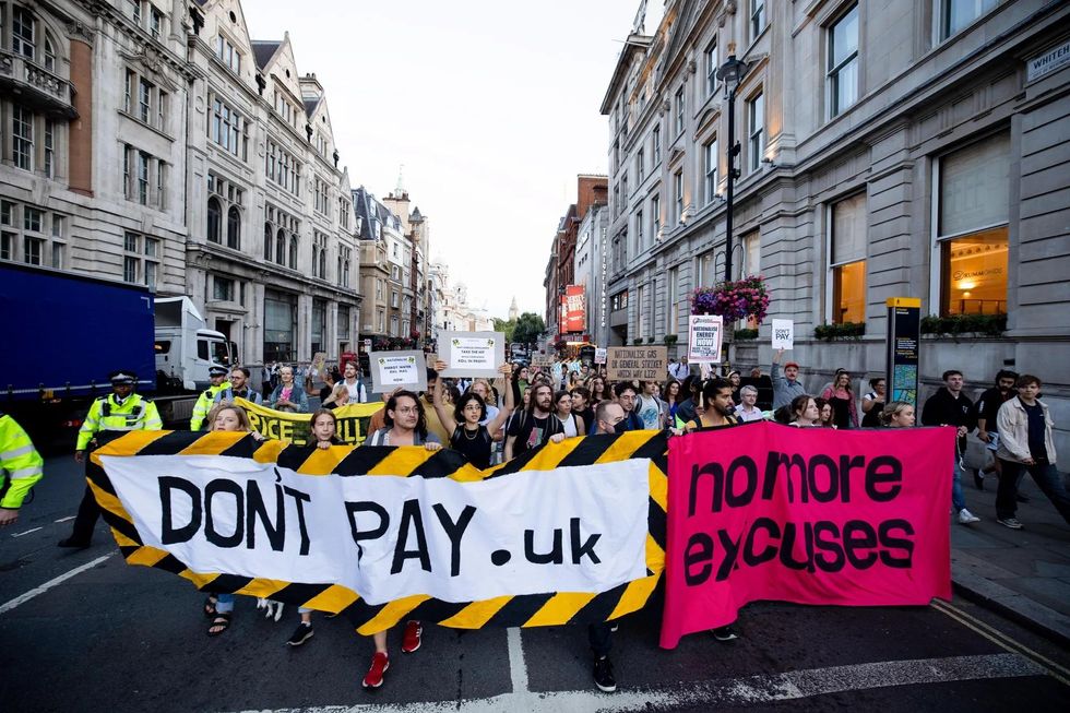 Protesters from ''Don't Pay UK'' (DPUK) initiative hold banners outside 10, Downing Street