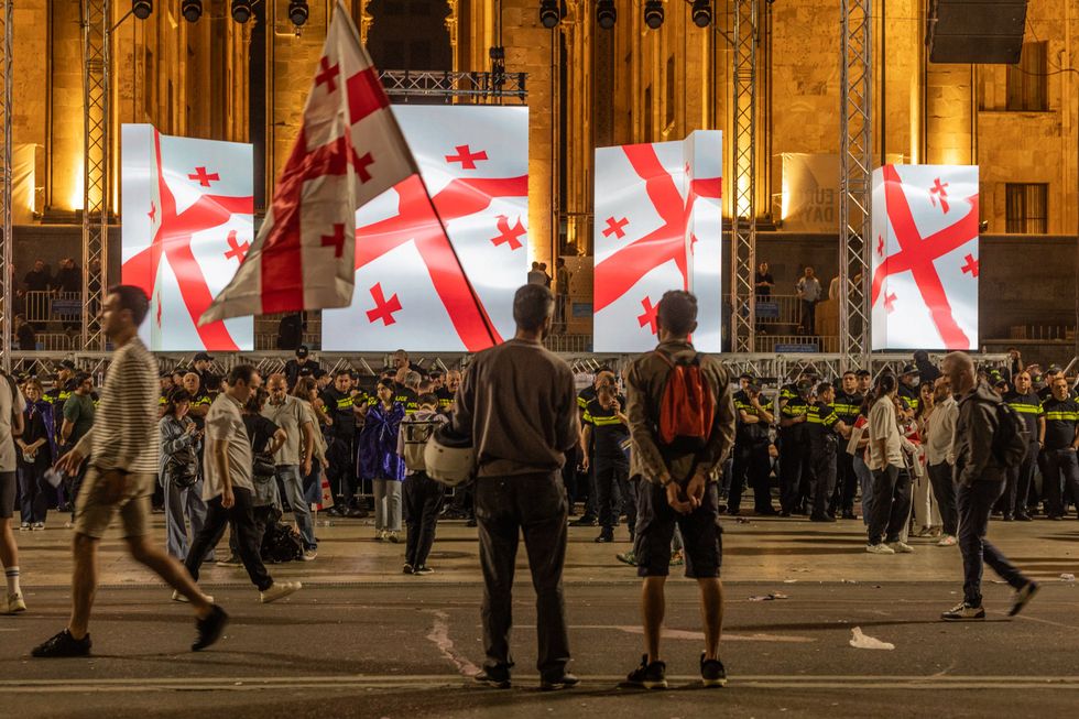 Protesters stand in front of the Georgian Parliament in Tbilisi.
