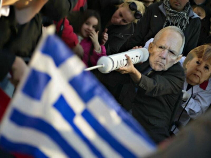 Protesters wearing Schauble and Merkel masks in Athens