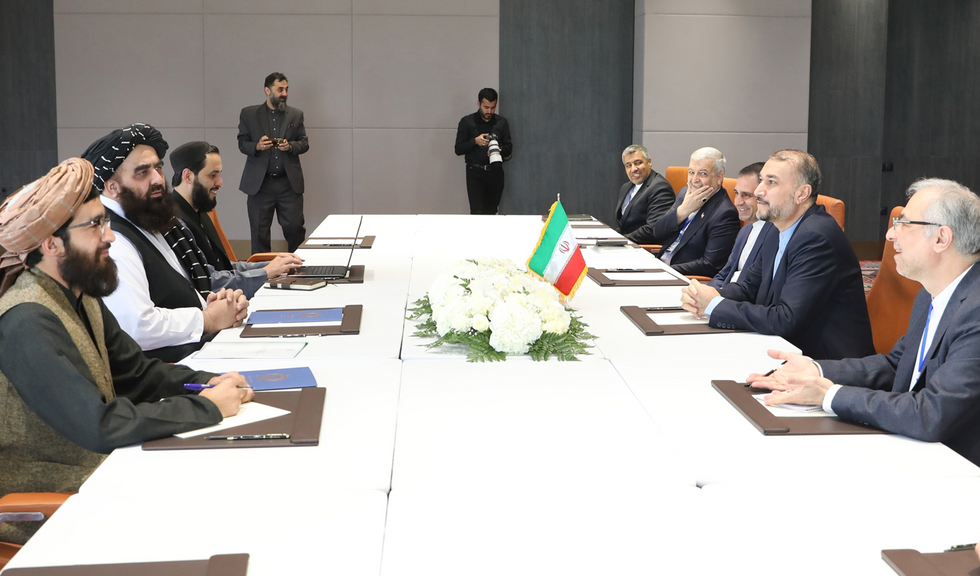 ran's Foreign Minister HOSSEIN AMIR ABDOLLAHIAN (2R) meets with Afghanistan's acting Foreign Minister, MOLAWI AMIR KHAN MOTAQI (2L), in Samarkand.
