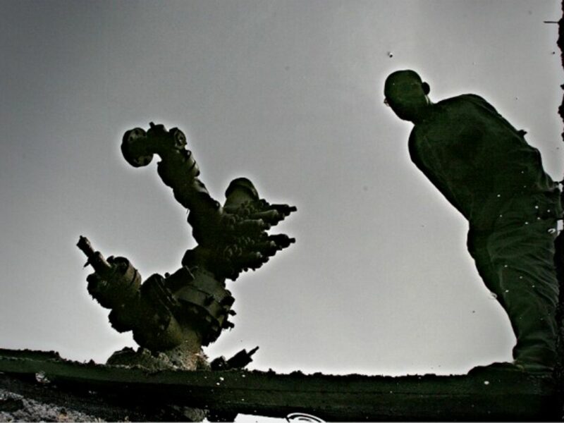 Reflection of a man in a crude oil spill in Ogoni, Nigeria