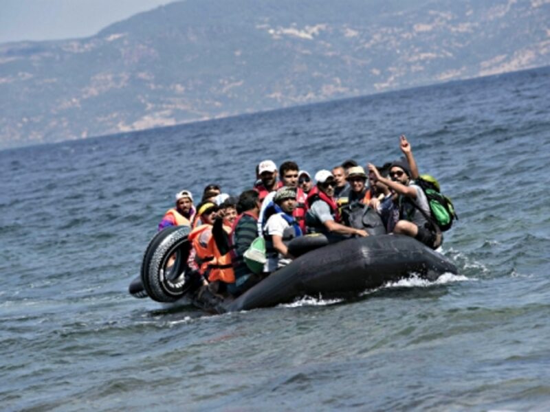 Refugees approaching the Greek shore after making the crossing from Turkey