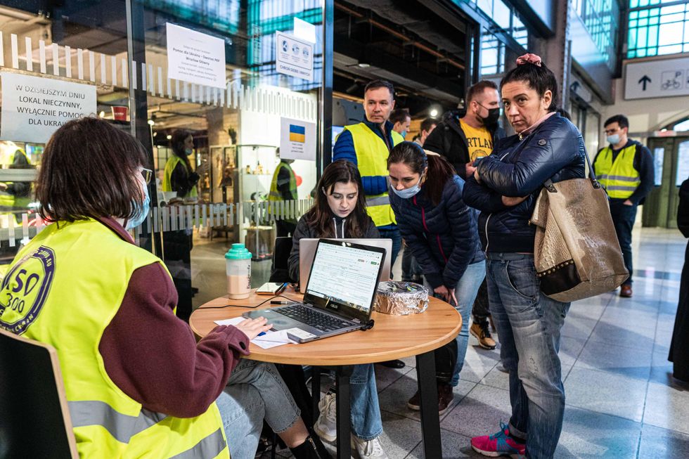 Refugees fleeing Ukraine at an information point established at the main railway station in Wroclaw