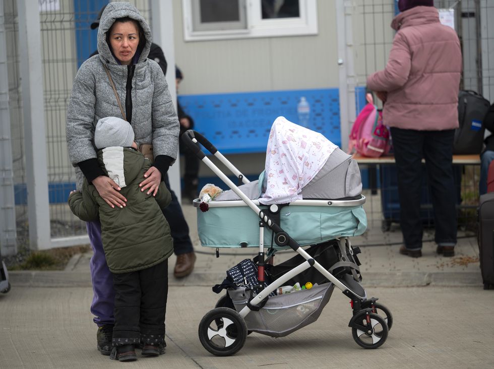 Refugees from the war in Ukraine disembark from a ferry at Port Isaccea in eastern Romania