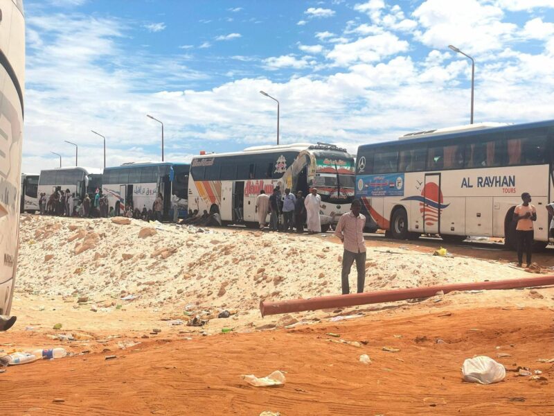 Refugees offloading from buses.