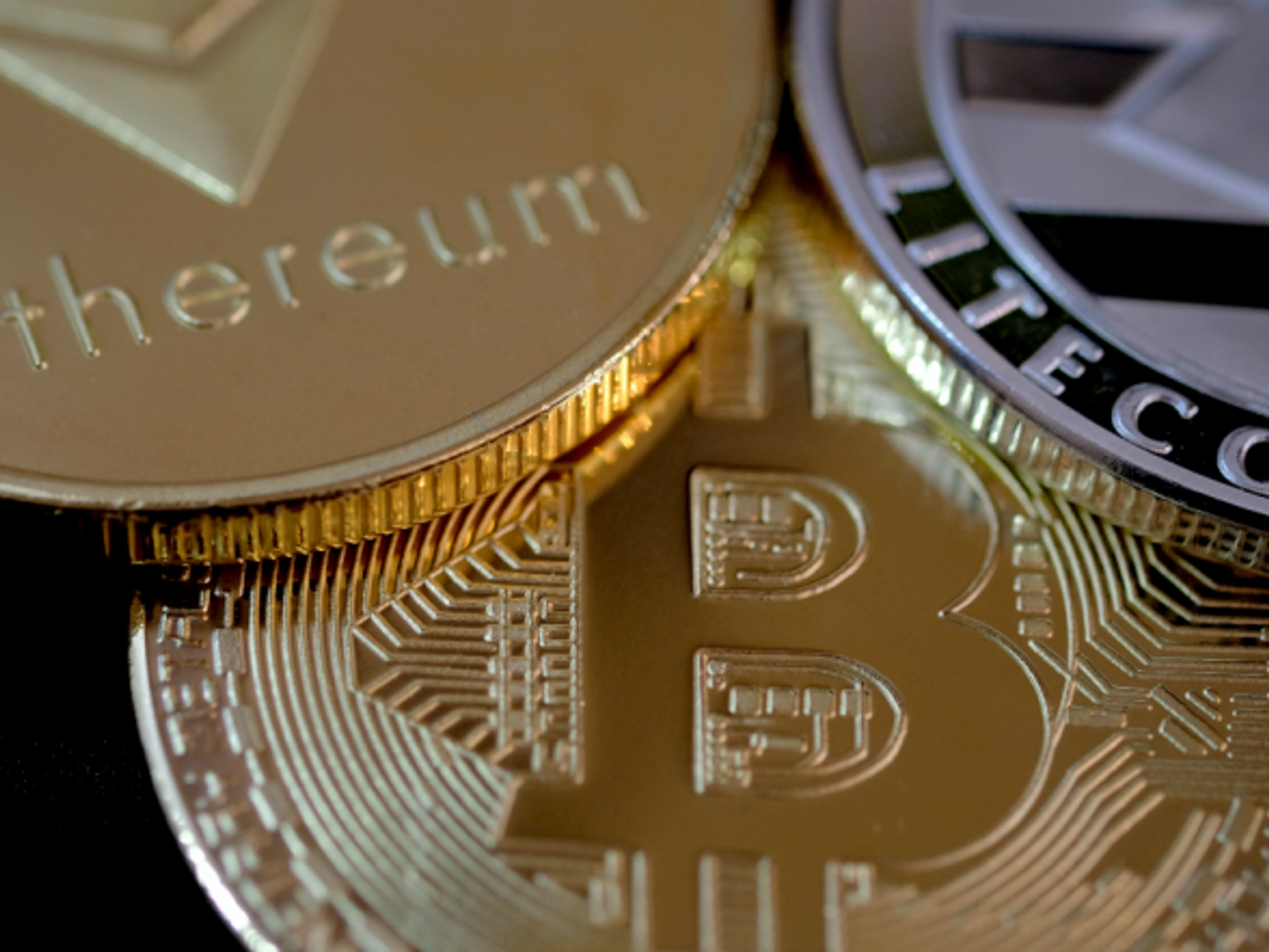 Representations of Bitcoin, Ethereum and Litecoin virtual currencies.