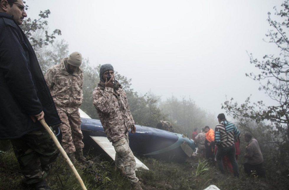 Rescue team members work at the crash site of a helicopter carrying Iran's President Raisi in Varzaghan, in north-west Iran.
