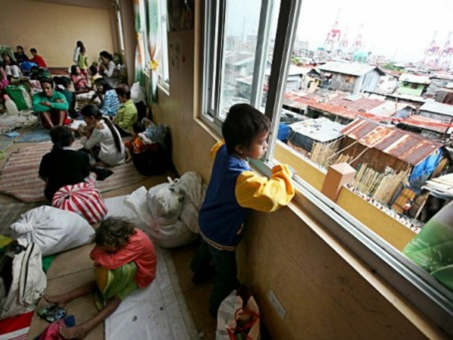 Residents in Manila take shelter from Typhoon Hagupit.