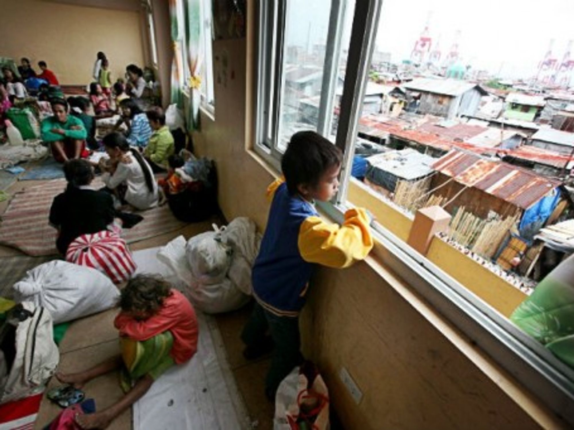 Residents in Manila take shelter from Typhoon Hagupit.