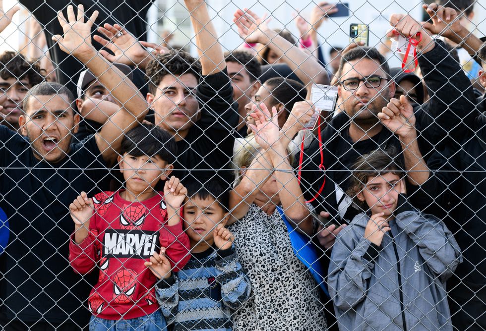 Residents of a refugee camp in Malakasa, Greece react emotionally to a visit from Federal President Steinmeier on Oct. 30, 2024.